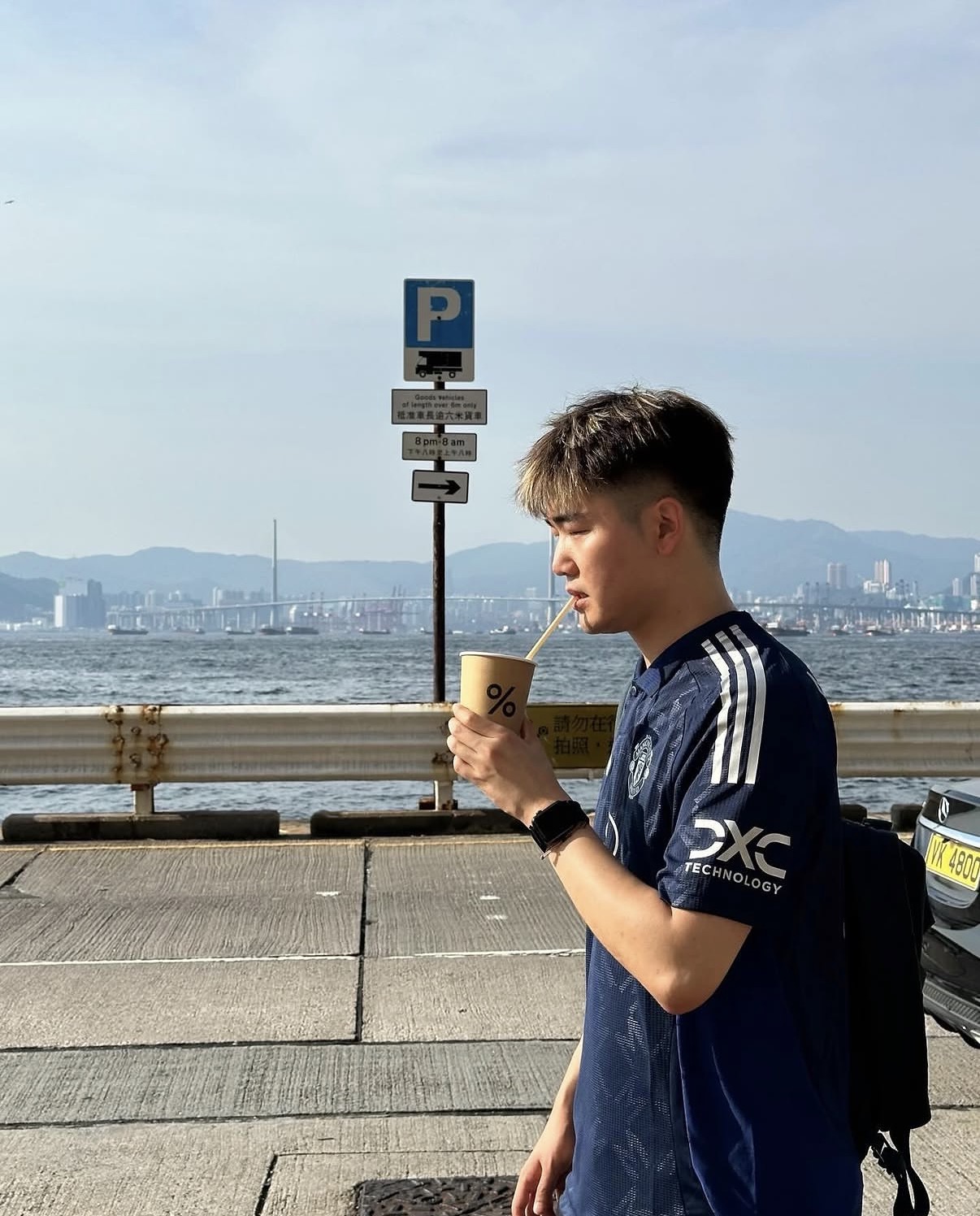 On the Hong Kong waterfront in a football shirt